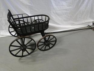 An early primitive wood wheeled goat cart in original: An early primitive wood wheeled goat cart in original paint.