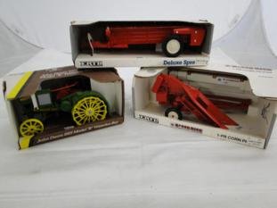 A group of farm toys including an Ertl deluxe: A group of farm toys including an Ertl deluxe spreader, John Deere 1950 Model R Waterloo Boy, Ertl International Harvester McCormick 1-PR corn picker.