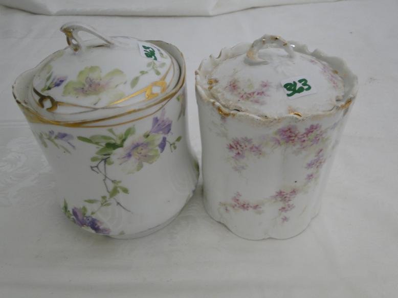 Two hand painted covered biscuit jars; one by Monbijou;: Two hand painted covered biscuit jars; one by Monbijou; the other by B. R. C. Alice Bavaria.