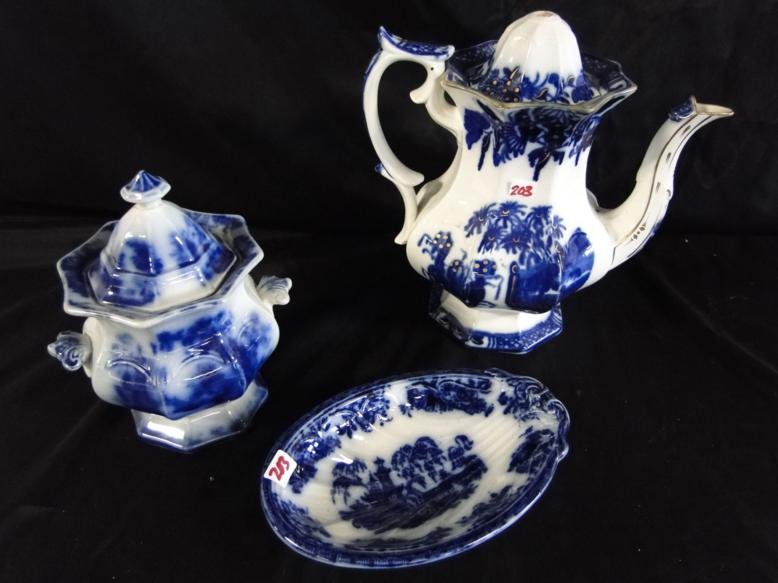 A group of flow blue accessories to include covered: A group of flow blue accessories to include covered sugar bowl (repaired finial noted), large tea pot in oriental pattern (finial missing but in good shape) and a spoon catcher in oriental pattern in