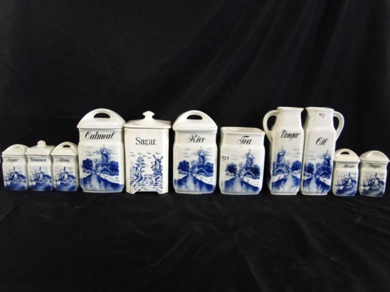 A canister set with windmill decoration made in: A canister set with windmill decoration made in Germany. Consists of 3 covered jars, 2 oil dispensers, 5 miniature jars and one open jar.