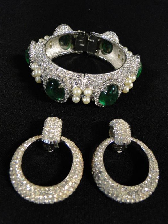 A set of Ciner rhinestone earrings and an elaborate: A set of Ciner rhinestone earrings and an elaborate hinged rhinestone bracelet with green colored stones