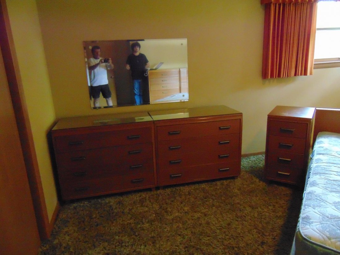 Seven piece late 50s oak bedroom suite consisting of: Seven piece late 50s oak bedroom suite consisting of pair of four drawer chests, pair of four drawer nightstands, pair of six drawer highboys, and queen sized bed. Signed Oakmasters Modern.