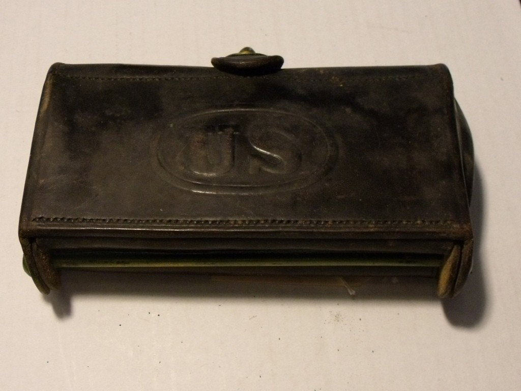 Cartridge Box, US: US Model 1874 McKeever Cartridge Box, Black Leather, Brass escutcheon plate & Rock Island Arsenal present on closing flap, Approx. 6.5" wide, Inside webbing fine condition, Leather in Very good condit