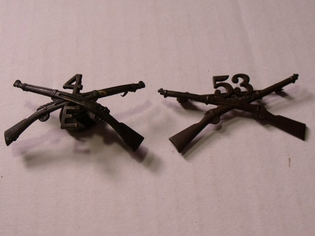 Two Spanish American Infantry Badges: One is number 53, the other is 4E.