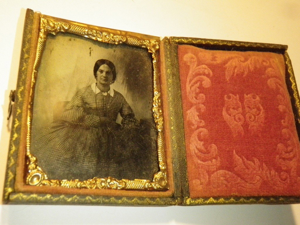 Daguerreotype: Shows young woman seated in chair. Comes in a velvet frame.