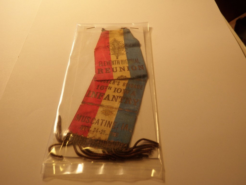 Crocker's Brigade 16th Iowa Infantry Ribbon: Reads "Eleventh Biennial Reunion Crocker's Brigade 16th Iowa Infantry - Muscatine, IA, Sept, 24-25, 1902". Tear in ribbon.