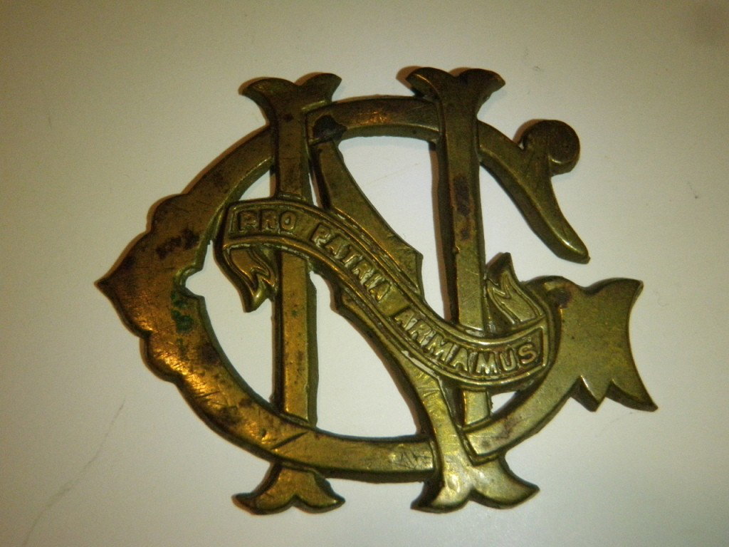 Pair of post Civil War Cartridge Box Plates: Marked "Pro Patria Armamus". Circa 1880's, They are made of stamped brass with the lead fill in the reverse to make them heavier and more durable and to hold the brass loops in place. It has the "NGâ