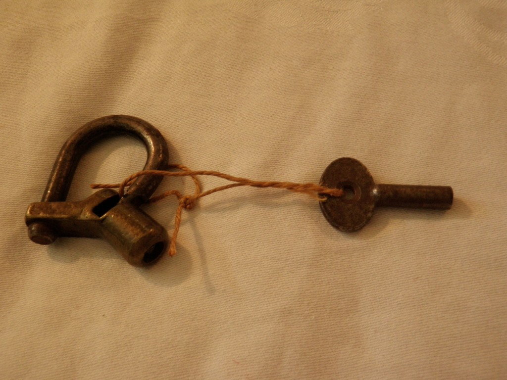 Antique Lock With Key: No identifying marks on this antique lock. It has the key and does work. This has an unusual design.
