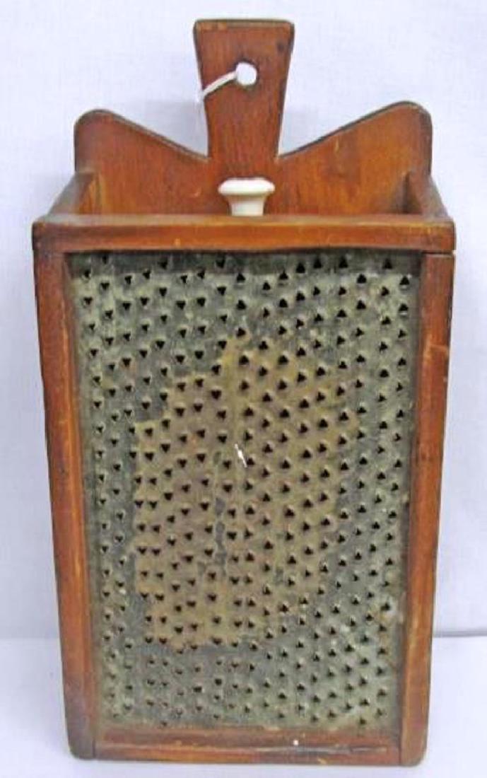 1870s Hanging Grater in Excellent Condition The tin: 1870s Hanging Grater in Excellent Condition The tin grater is in excellent condition and the porcelain pull is original. It is 14 inches long and 7 inches wide.