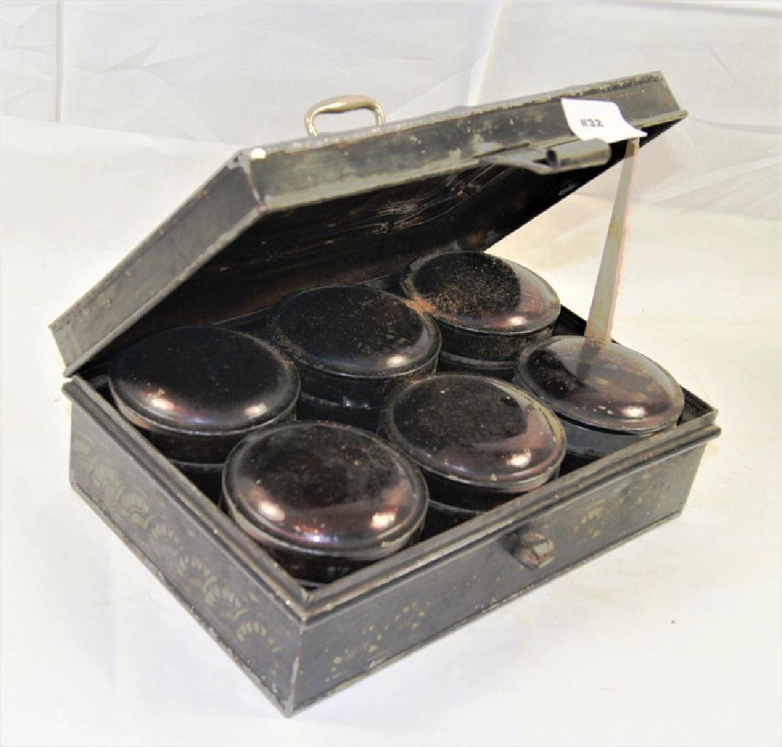 Black painted tin spice travel box with brass handle: Black painted tin spice travel box with brass handle and tab lock with finely detailed painted gold decoration on top of serpentine shaped lid, inside cannisterswith with gold stencilled lettering on 