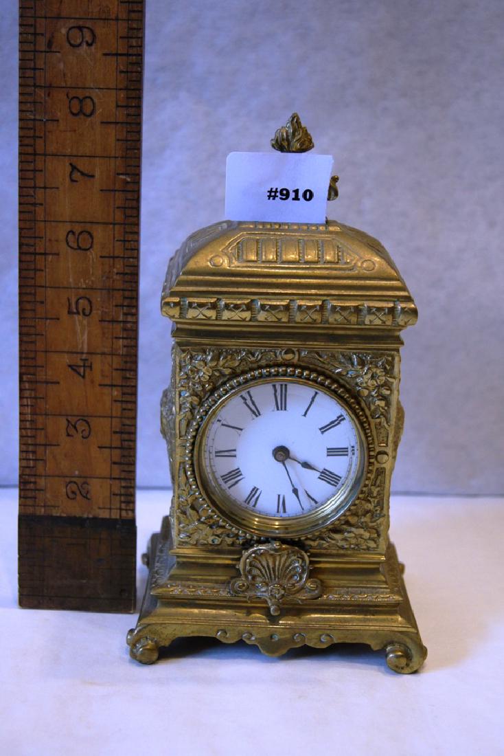 Miniature Fancy Brass Novelty Clock with white: Miniature Fancy Brass Novelty Clock with white porcelain dial, roman numerals, wind on the rear of clock, nice quality timepiece, ca 1900, 6" ht.