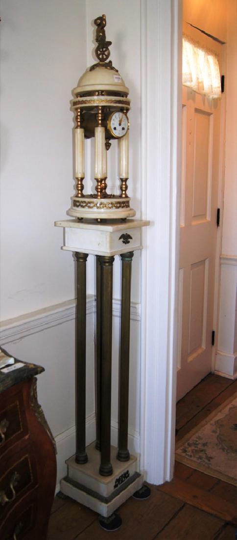 White marble portico clock with circular onyx top and: White marble portico clock with circular onyx top and base with ormolu mounts and a Monticello dome w/cupid on a unicycle finial, and sideways brass cylinder housing a French 8d t&s movement with whit