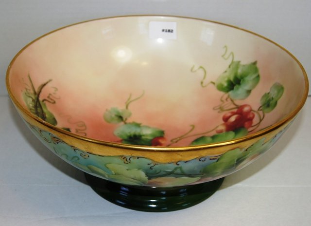 Limoges hand painted punch bowl with purple, red and: Limoges hand painted punch bowl with purple, red and green grapes decoration over a soft and dark green background, beneath is the green "T & V / Limoges" stamp, 14" dia. 6" ht.This punch bowl is in p