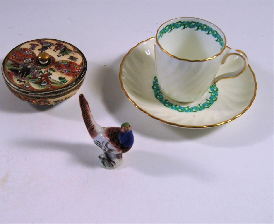 Lot of 3 items incl Minton cup and saucer, Satsuma: Lot of 3 items incl Minton cup and saucer, Satsuma covered pillbox, 1" ht., 3" dia, ,and a Meissen miniature pheasant figurines, rare, with crossed swords, 1" ht.