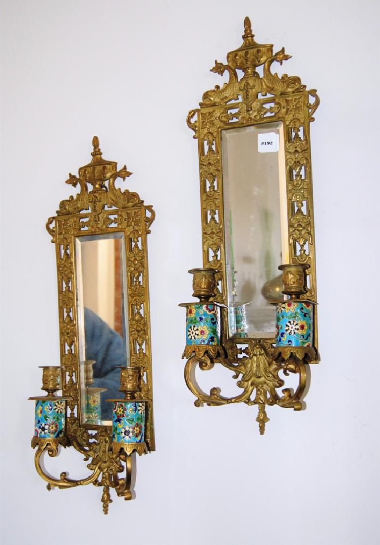 Pair of Bradley & Hubbard Cast Brass and Longwy Faience: Pair of Bradley & Hubbard Cast Brass and Longwy Faience Mirrored Two-Light Wall Sconces, Longwy cylinder decorated candle holders, each has a hanging brass loop on the back for hanging. A small, antiq