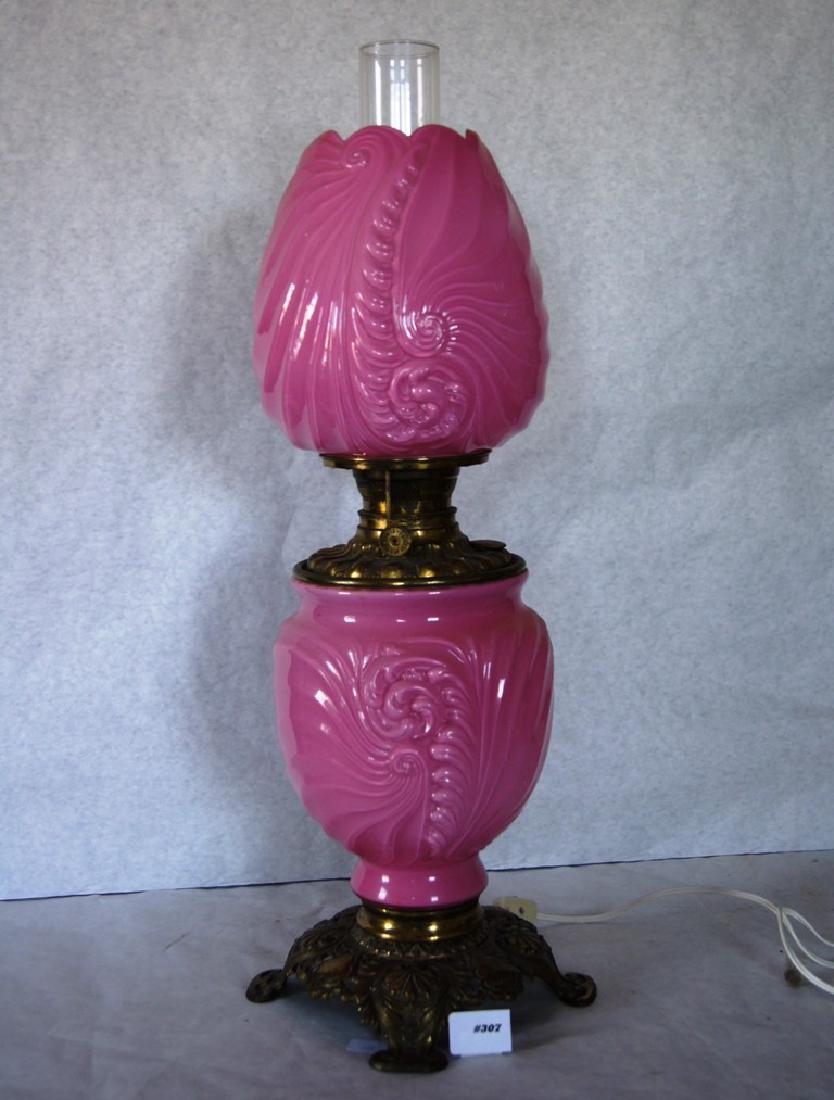 Plume and Atwood Mfg. Co. Gone With The Wind lamp with: Plume and Atwood Mfg. Co. Gone With The Wind lamp with unusual bas relief nautilus shell design on font and shade all in a pleasing pink glass, has been smartly electrified so bottom and shade to ligh