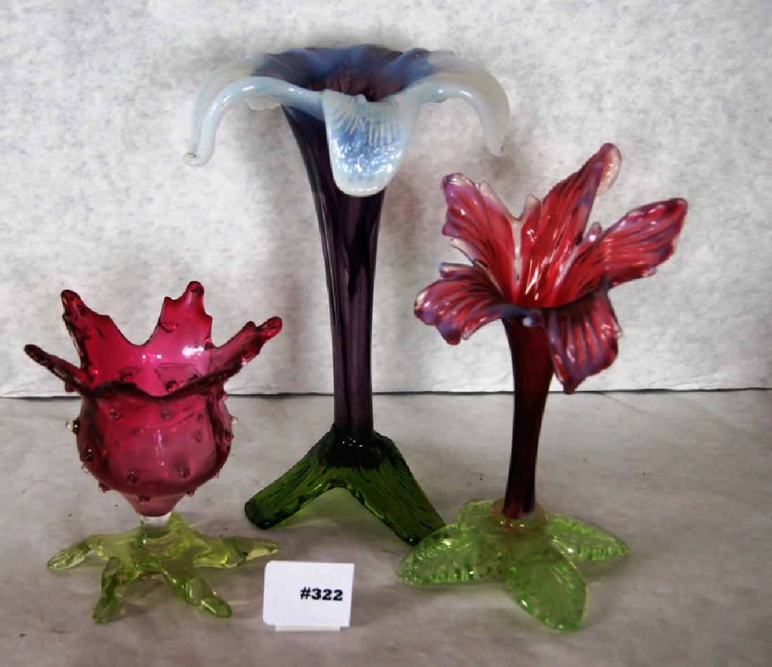 3 Victorian art glass floriform vases one a 8" purple: 3 Victorian art glass floriform vases one a 8" purple glass with opalescent blue petals 3 green leaf feet, a 7" cranberry glass with Vaseline leaf pedestal, and 4" cranberry hobnail with 5 petals and 