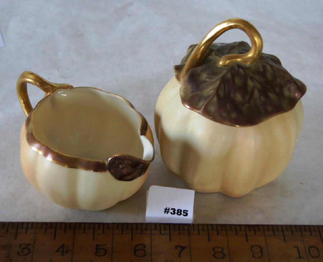 Royal Worcester melon form creamer and covered sugar: Royal Worcester creamer and covered sugar with melon-form bodies, the sugar lid is in the form of melon leaves in gold leaf, with R.W. purple C 51 hallmark on bottom, ca. 1890; 3" ht