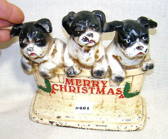 Cast iron John Wright Xmas doorstop, 3 b&w Bulldo: Cast iron John Wright Xmas doorstop, 3 b&w Bulldogs & basket, raised "Merry Christmas", nice paint, Seidman cost $95, 6 1/2" ht, 8" wd., ca 1970, Cond.: VG, paint chips