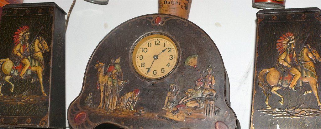 Advertising tin clock set, English, Victory Lozanges &: Advertising tin lithograph clock set, English, Victory Lozanges & Gums, there is an American Indain cheief with full headress on one side of side tin and an Arab warrior w/long gun on the back side, b