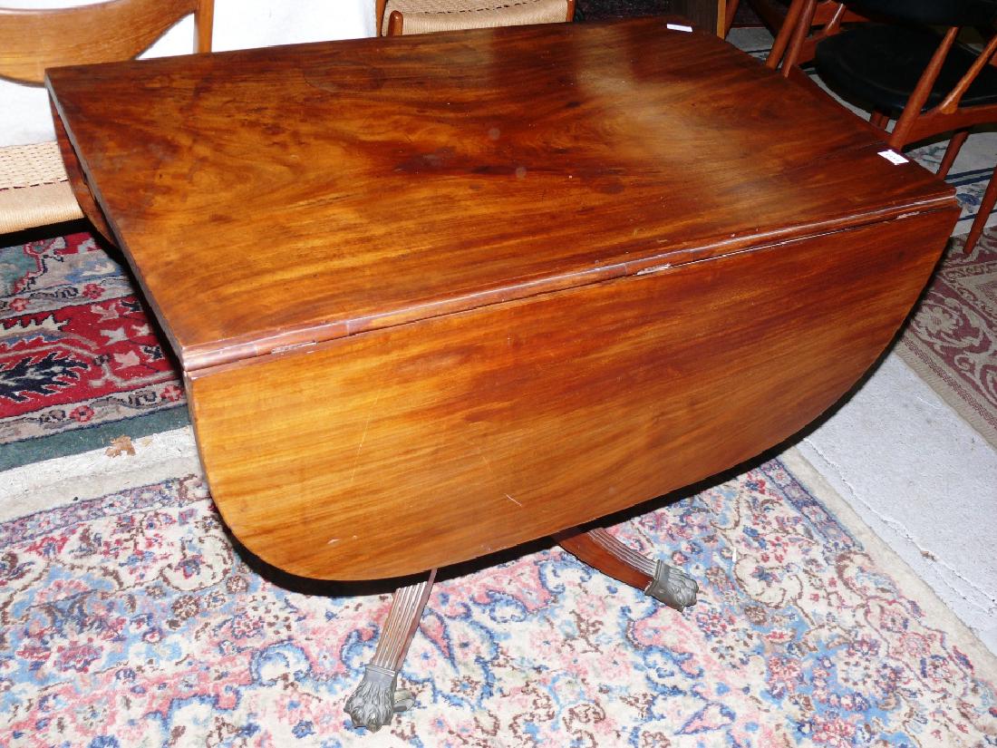 Duncan Phyfe drop-leaf table, w/crotch mahogany top: Antique classical Empire sabre drop-leaf table, w/crotch mahogany top, 38" lg., each of the drop leaves is 14" wide, open measures 52" long x 38" wide, sturdy reeded sabre legs supported on nice origi