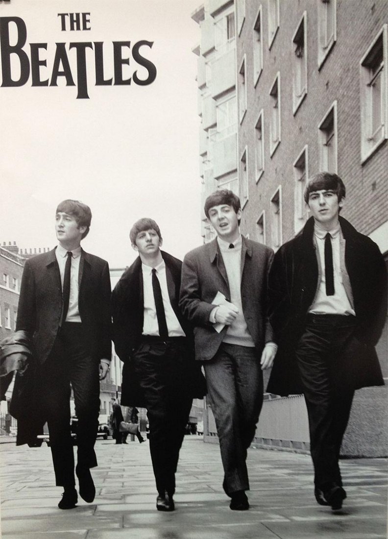 MUSIC POSTER: MUSIC POSTER **|**|** 24X36 INCHES; UNFRAMED; This poster shows a black and white photo of the Beatles walking down the street in suits. At the top it says 'The Beatles'. The Beatles were a pop and ro