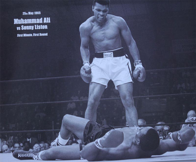 Muhammad Ali black and white classic qoute: Muhammad Ali black and white classic qoute **|**|** UNFRAMED; This black and white poster is an image from Muhammad Ali and Sonny Liston's second fight. Ali is Standing over Liston's body in a boxing 