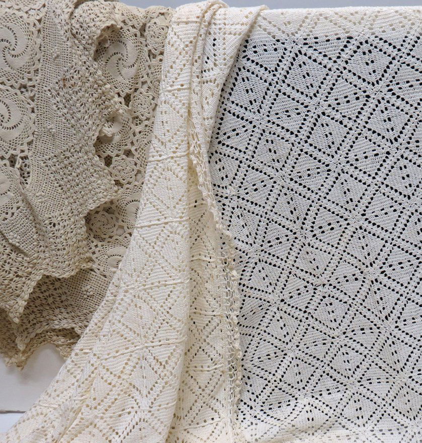 LOT OF LINENS - BED COVERS: 1930’s, all double bed size, (2) bedroom suites, ecru embroidered and cut-out lace bed cover, (2) curtain panels, (2) table runners, (4) doilies (good condition); the other, embroidered satin bedroo