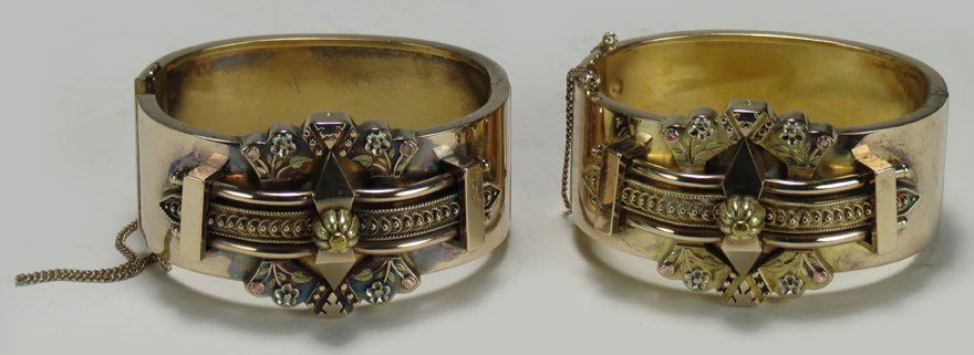 PAIR OF VICTORIAN GOLD CUFF BRACELETS: applied aesthetic decoration, approx. 31 dwt, guard chain, wrist opening 2.25” tested as 14K goldThe home of a Massachusetts couple.