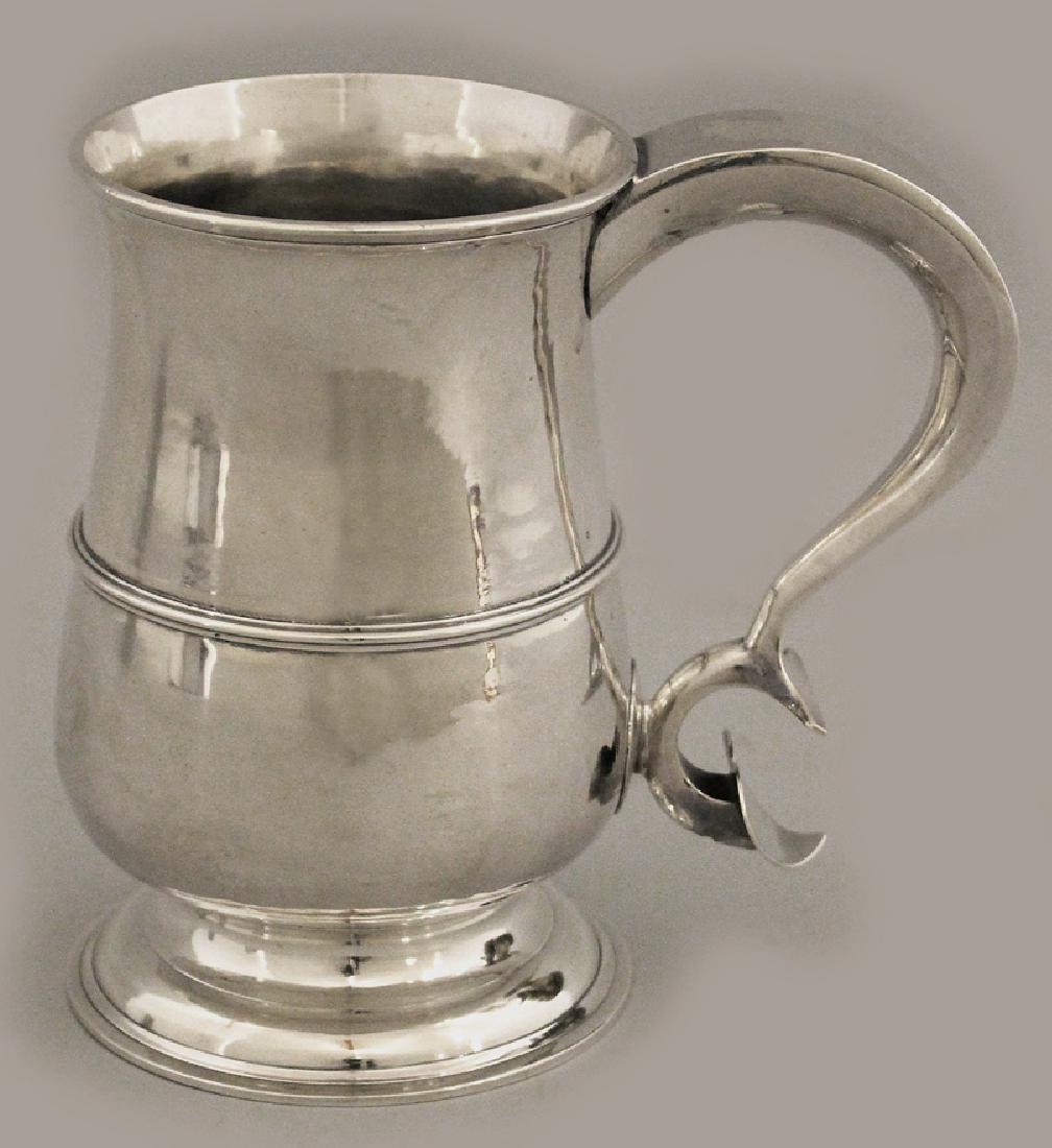 GEORGIAN SILVER FOOTED CANN: James Robertson, New Castle, 1797 flared rim, ribbed bulbous body and with unusual reverse scroll and heart handle 6”h; 16 troy oz.