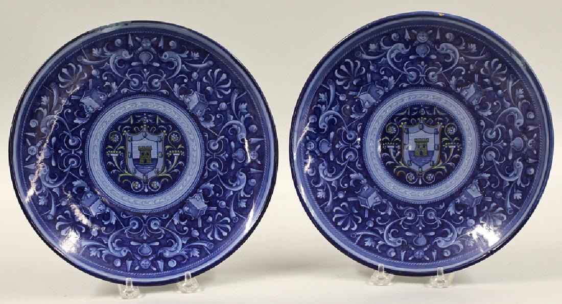 PAIR OF ITALIAN CANTAGALLI MAIOLICA BLUE PLATES: Faenze-style, late 19th/early 20th c., center with heraldic shield surrounded by border of dolphins and trophies, cockerel mark and Made in Italy, 10.5” From the collection of a Boston, Massachu