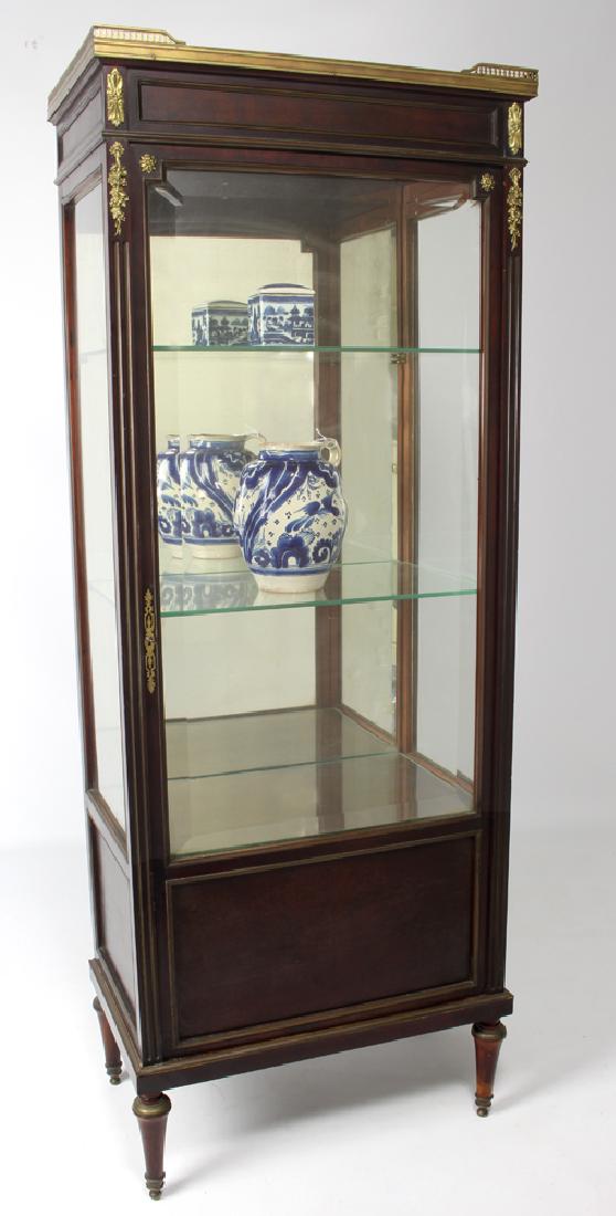 LOUIS XVI-STYLE ORMOLU MOUNTED CURIO CABINET: marble top, three glass shelves, mirrored back, 54"h; 20"w; 12.5"d