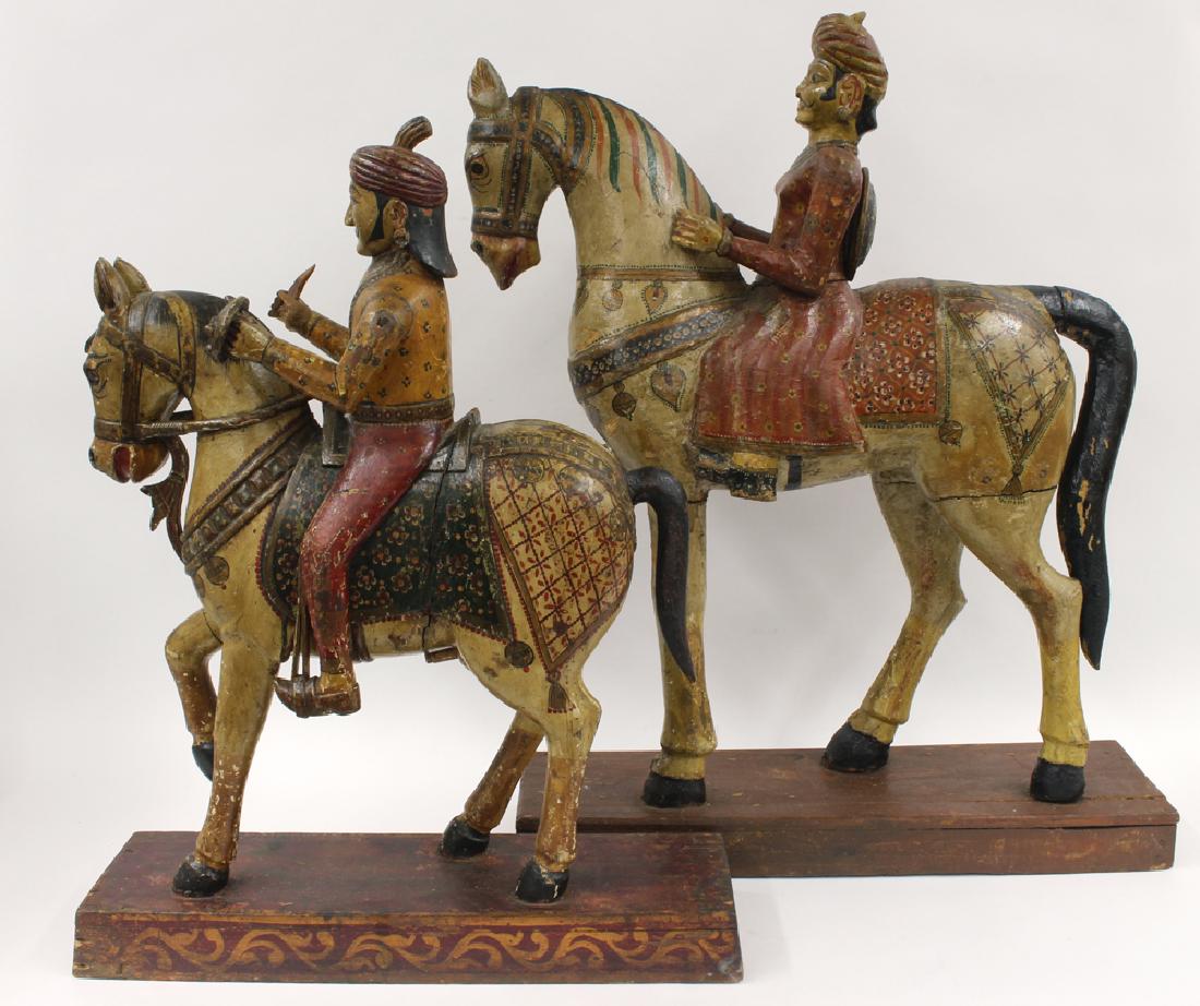 (2) MUGHAL CARVED AND POLYCHROMED WARRIORS: 19th c., one, 24"h; 20.5"w; 6.5"d; the other, 28"h; 24"w; 7"d; both mounted on 2" painted plinth