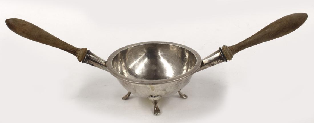 RARE AMERICAN SILVER FOOTED WINE TASTER, EPHRIAM COBB: marked under edge of rim E.C (Ephraim Cobb, Boston, 1708-1777) hammered round bowl on four paw feet with double turned wooden handles. 4"diam.; 12" handle t
