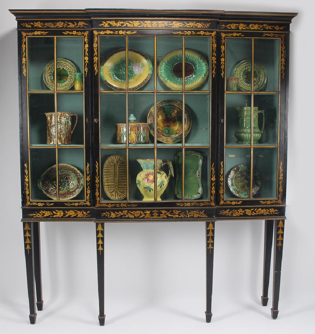 ENGLISH EDWARDIAN JAPANNED DISPLAY CABINET: black and gold chinoiserie floral decorated exterior, three glazed doors, the blue painted interior with shelves painted blue and three cabinet lights; on tapering legs, 73"h; 62"w; 9.75&quo