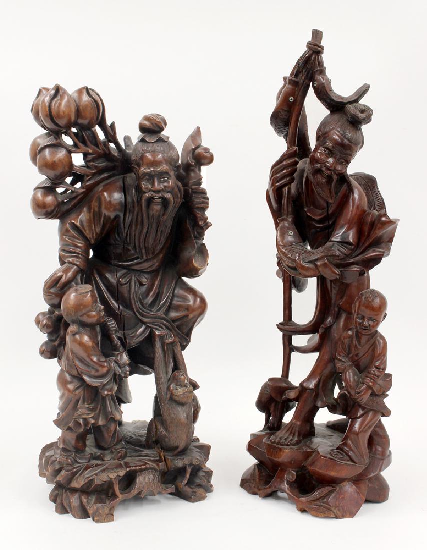 (2) CHINESE CARVED WOOD FIGURES: one a philosopher with a boy and monkey, 16.5" (vertical age split from base to shoulder; one glass eye missing on man); the other, more recent, fisherman and boy, 1