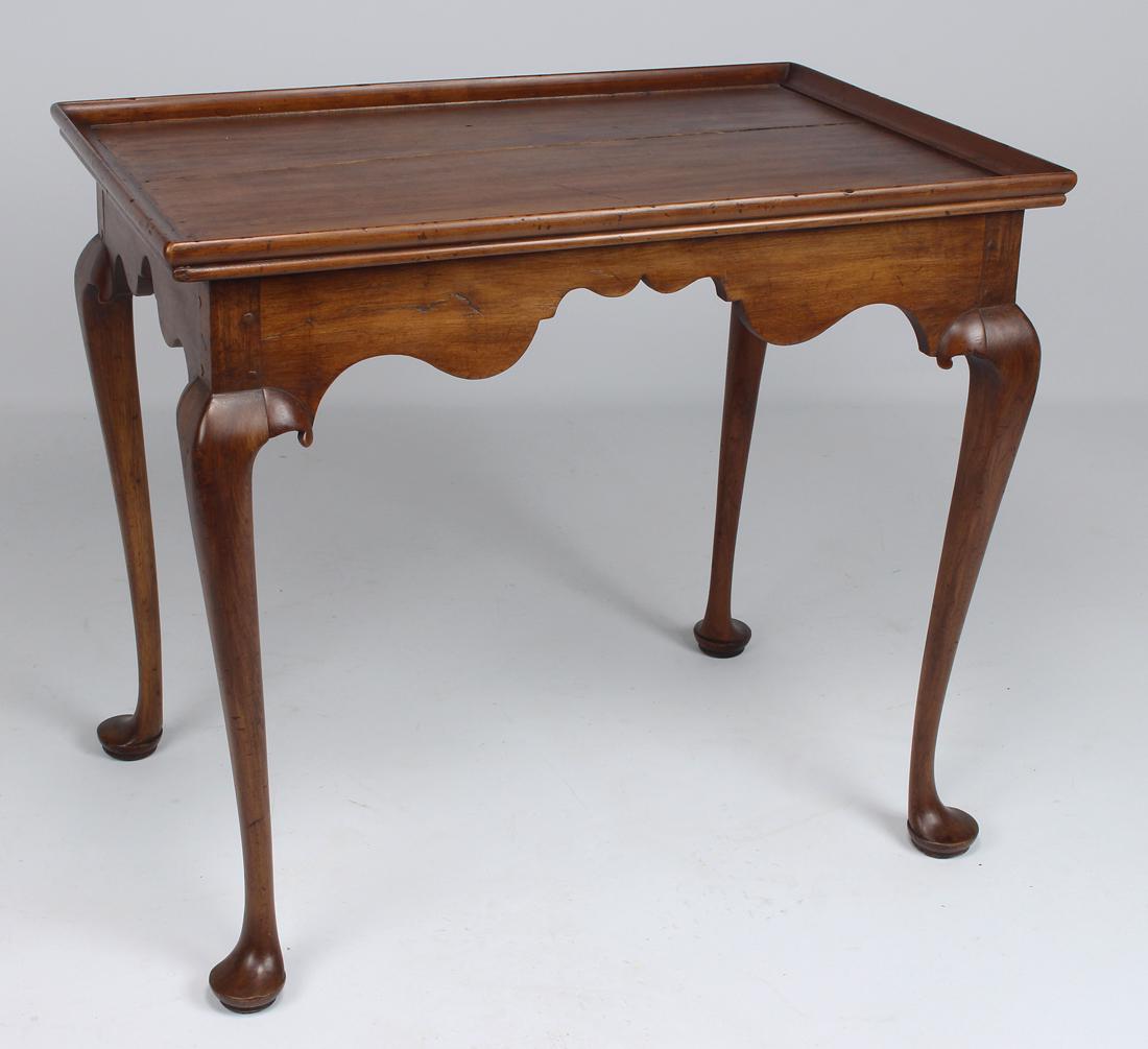 NEW ENGLAND QUEEN ANNE CHERRY TEA TABLE: 18th c., molded tray top, shaped skirt, cabriole legs on pad feet, 26"h; 30"w; 19"d