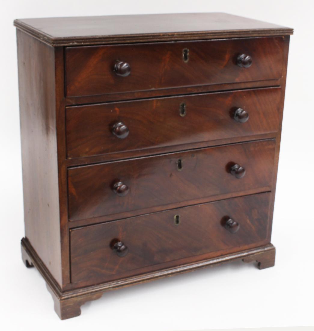 ENGLISH GEORGIAN MAHOGANY MINIATURE CHEST: four graduated drawers with wood knobs, bracket feet, 13.5"h; 12.5"w; 6.5"d From the collection of a New Rochelle, New York gentleman, purchased from Nancy Cody, Pound Ridge, NY in 1996