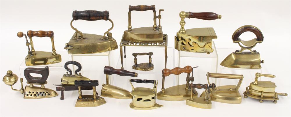 (on 19) COLLECTION OF MINIATURE BRASS FLAT IRONS: various countries of origin, fifteen irons and four trivets, some with turned wood handles, ranging in size from 2" to 5" English, one 18th c. Netherlands, etc. From the collection of a New