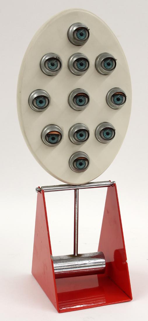 ENNIO CHIGGIO (Italian, b. 1938) KINETIC SCULPTURE: Occhi di Bambola, 1982, ten lidded eyes open and shut; on reverse dentro gli occhi piu scure si chiudone i piu chiari P. Eluard..E. Chiggio/Occhi di Bam