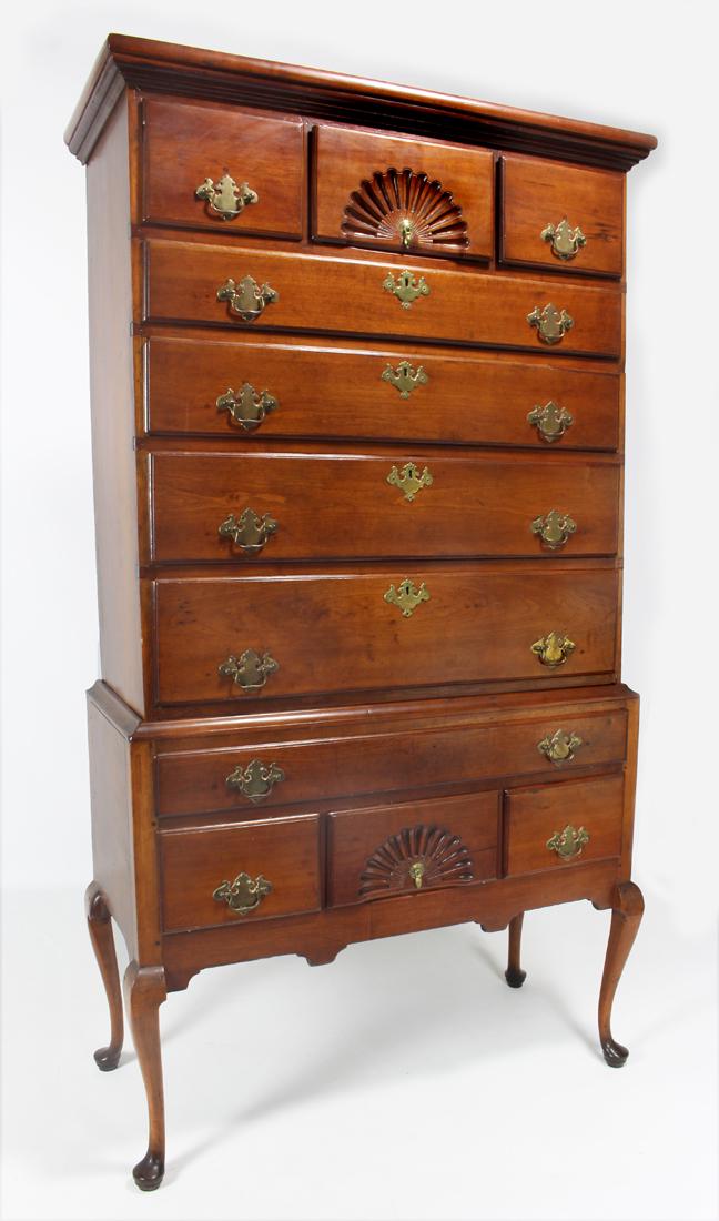 NEW ENGLAND QUEEN ANNE CHERRY HIGHBOY: top part with three drawers over four long drawers; bottom part with one long drawer over three, the center drawers shell-carved; on pad feet, 73"h; top part 37"w; 16"d; bottom 39.5&quo