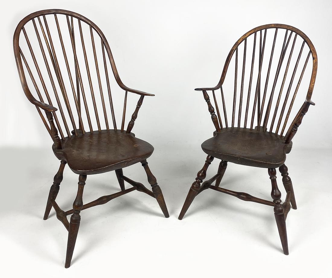 NEAR PAIR OF BRACE-BACK WINDSOR ARMCHAIRS: 18th c., Rhode Island, continuous arms, splayed turned legs joined by stretcher, one, 40.25"h; the other, 42"h; both seats, 16"w One has 13 spindles, the other 11 (one less spindle unde