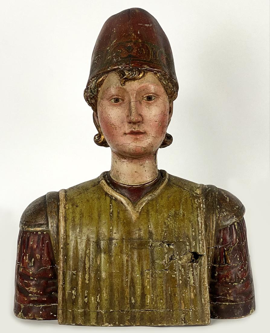 ITALIAN RENAISSANCE CARVED AND POLYCRHOMED BUST: 16/17th c., bust of young man wearing a cap with original and vivid paint, constructed typically with stacked vertical slabs of pine, 19"h; 14.5"w