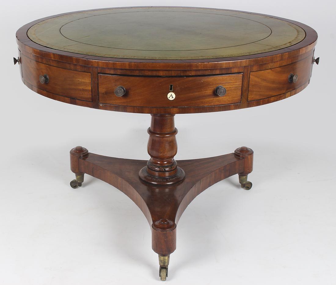 ENGLISH REGENCY MAHOGANY DRUM TABLE: inset tooled, green leather, rotating top, four false drawers alternating with four working drawers marked with inset bone labels (A, B, C, D); turned pedestal with trif