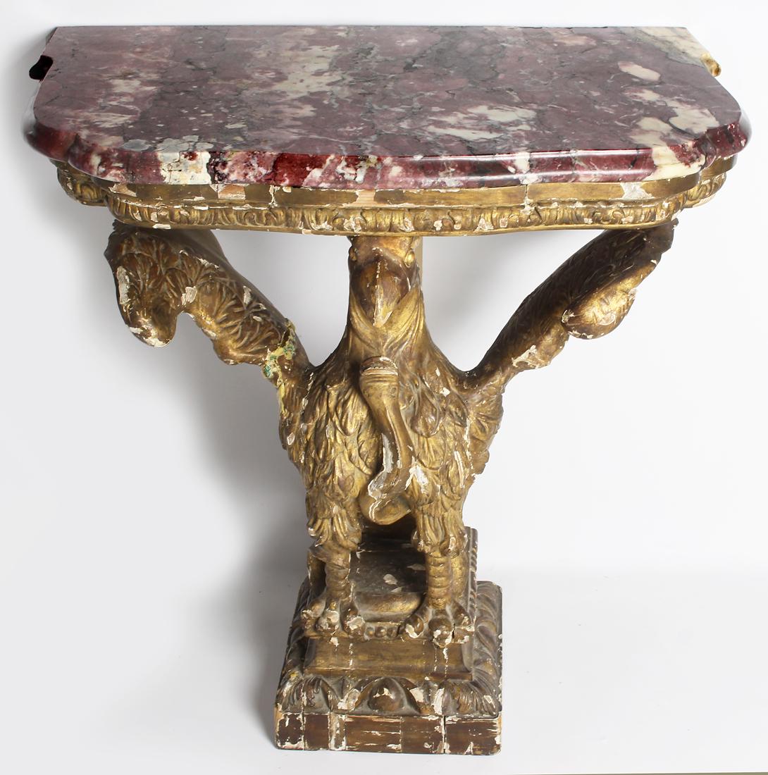 ENGLISH GEORGE III MARBLE-TOP CONSOLE TABLE: shaped, veined rouge marble top with molded edge, on carved giltwood eagle and serpent base, 32"h; 34"w; 22"d