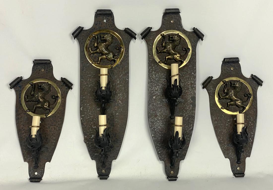 (on 4) ART DECO IRON WALL SCONCES: c. 1920's, scrolled, elongated shield-form, round brass rampant lion plaque, copper hammered patina throughout; a single-light pair, 22"h; the other, a double-light pair, 31"h Original to a 