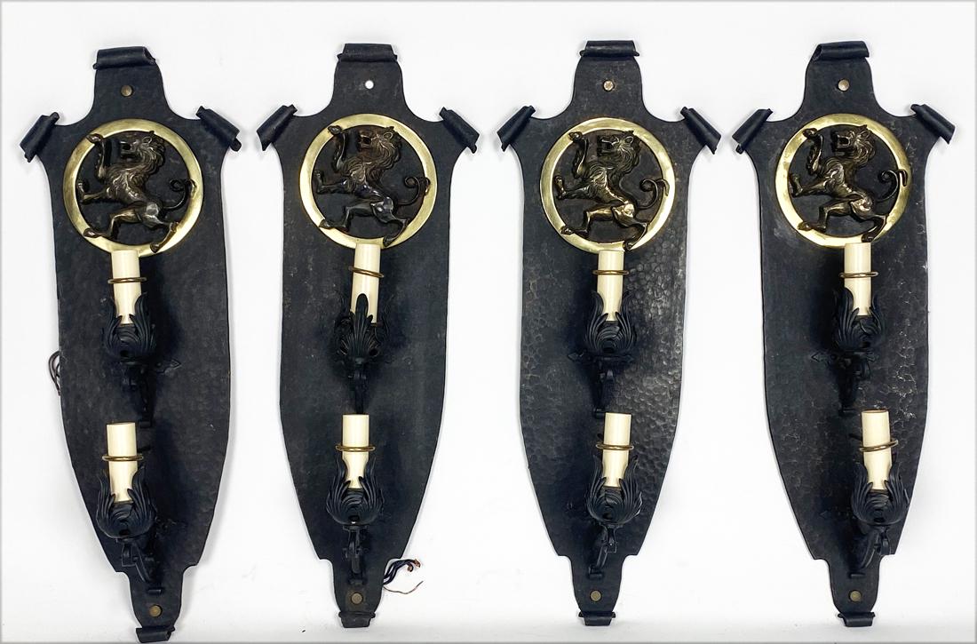 SET OF (4) LARGE ART DECO IRON WALL SCONCES: c. 1920's, scrolled, elongated shield-form, round brass rampant lion plaque, double fixture, hammered patina throughout, 31"h (matching the previous lot) Original to a Providence RI home, now bei