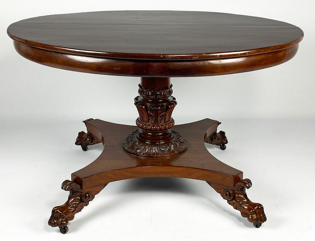AMERICAN CLASSICAL MAHOGANY TILT-TOP CENTER TABLE: prob. Pennsylvania, circular-top, carved center pedestal with claw feet on original castors, 29.5"h; 46"diam.