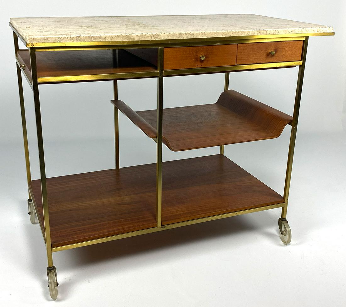 MID-CENTURY MODERN SERVING CART, McCOBB: Paul McCobb (1917-1969) for Calvin, Irwin Collection travertine top, brass frame, mahogany drawers and removable tray, 29"h; 36"w; 19.5"d McCobb was born in Medford, Massachusetts.